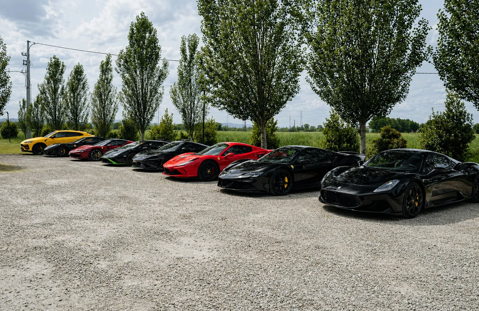 Supercar lineup on the gravel area in Tuscany
